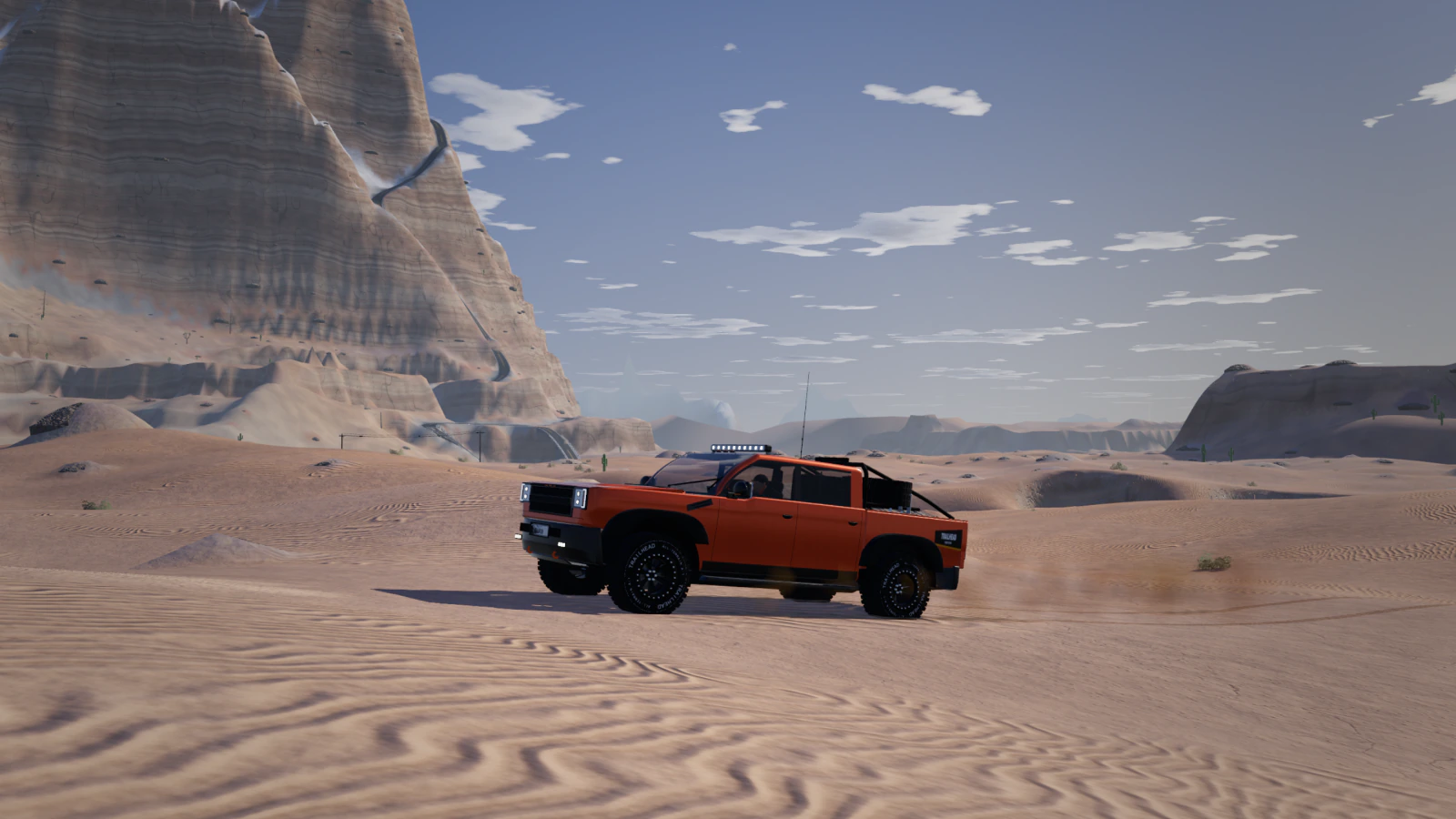 An orange Baja Trophy Truck kicking up sand among rippled dunes beneath a striped sandstone butte